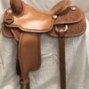 A saddle that is sitting on top of a white sheet.