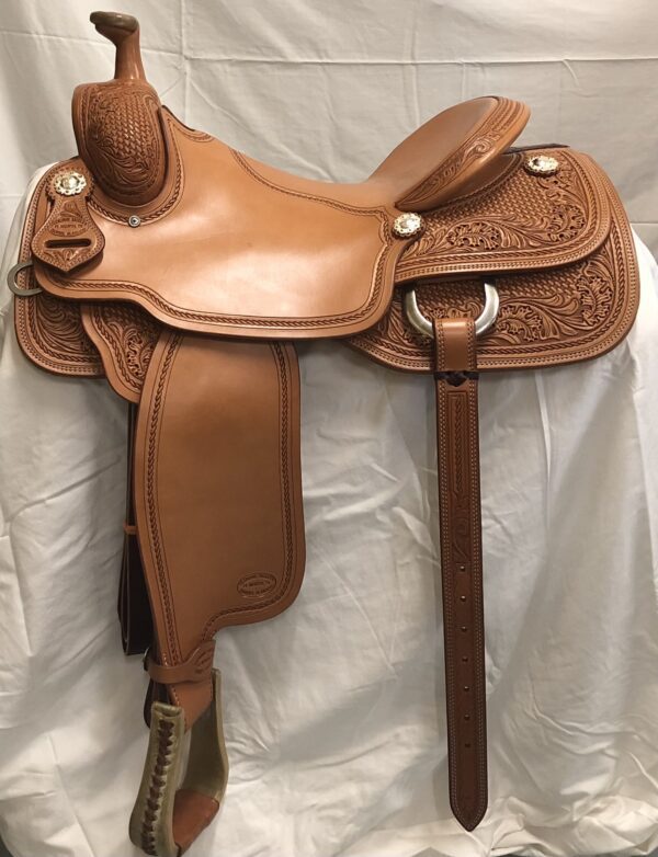 A saddle that is sitting on top of a white sheet.