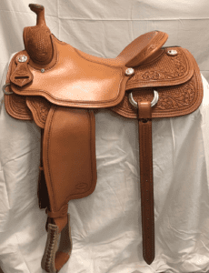 A saddle that is sitting on the ground.