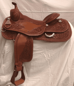 A saddle is shown on the ground.