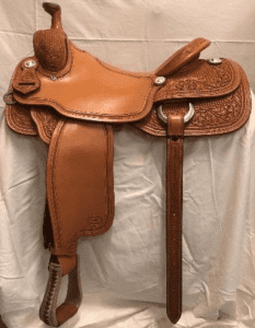 A saddle is hanging on the wall