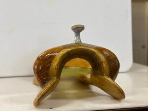 A wooden object sitting on top of a table.